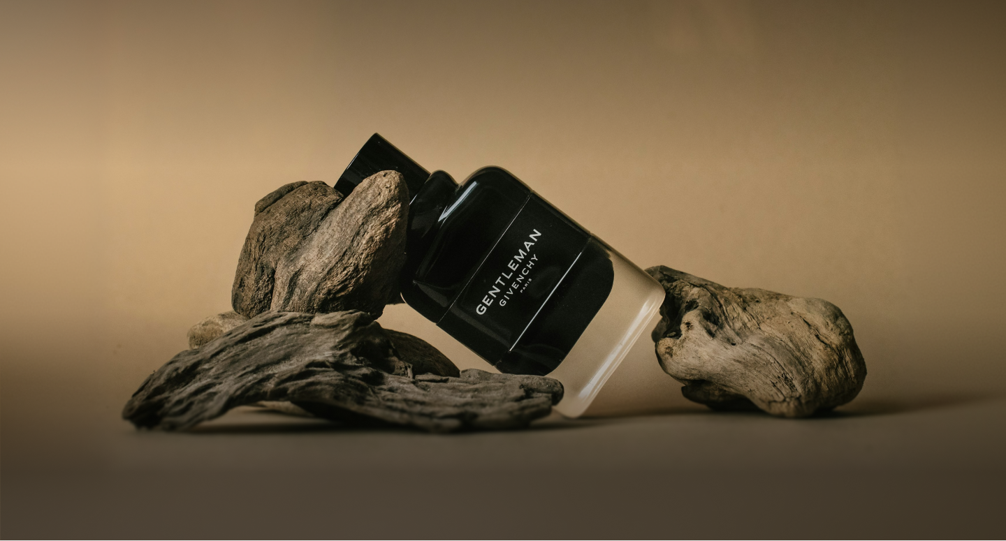 Gentleman — black bottle resting on driftwood